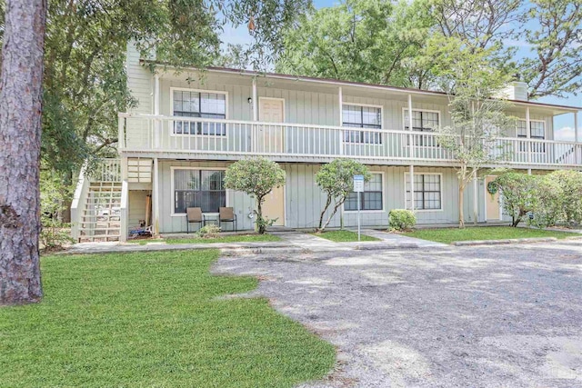2811 Langley Ave Unit 221, Pensacola, FL 32504 - view of front of house with stairs, a chimney, and a front yard