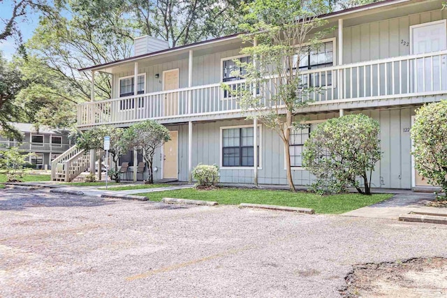 2811 Langley Ave Unit 221, Pensacola, FL 32504 - view of property featuring stairs and uncovered parking