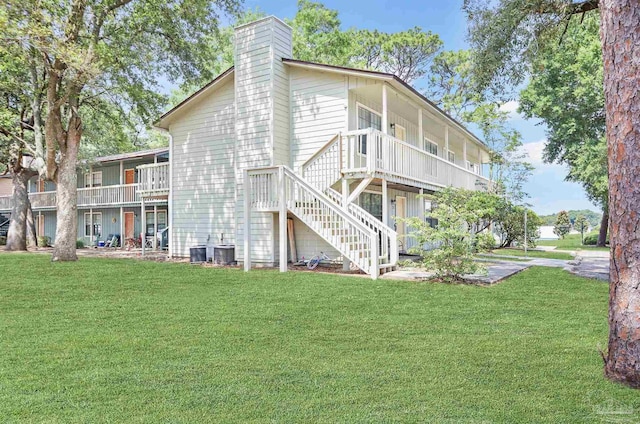 2811 Langley Ave Unit 221, Pensacola, FL 32504 - back of property with a chimney, a yard, stairway, and central AC unit