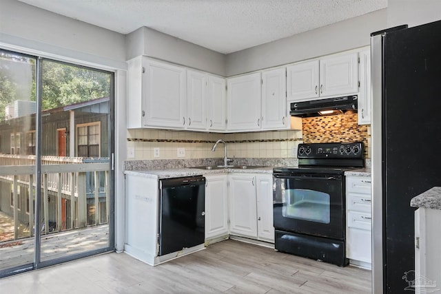 2811 Langley Ave Unit 221, Pensacola, FL 32504 - kitchen with black appliances, under cabinet range hood, white cabinets, a sink, and a textured ceiling