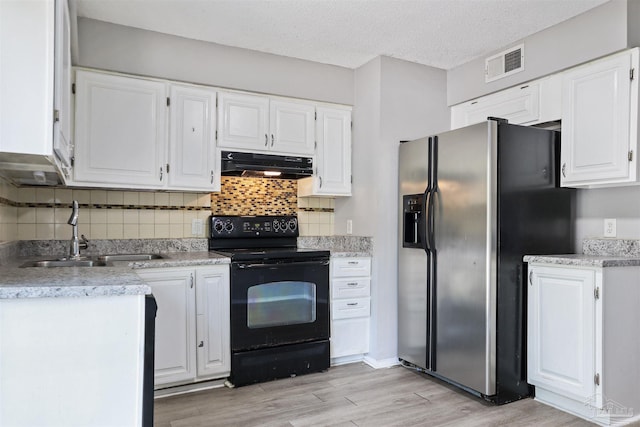 2811 Langley Ave Unit 221, Pensacola, FL 32504 - kitchen with electric range, stainless steel refrigerator with ice dispenser, a sink, under cabinet range hood, and white cabinetry