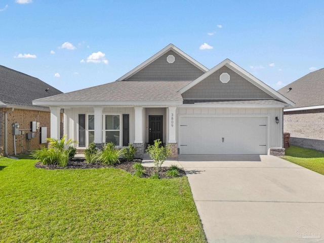 view of front of property with a garage and a front lawn