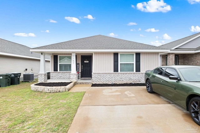 view of front of house with central AC, a front lawn, and covered porch