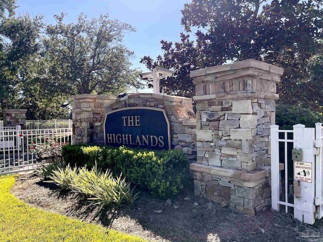 community / neighborhood sign with fence