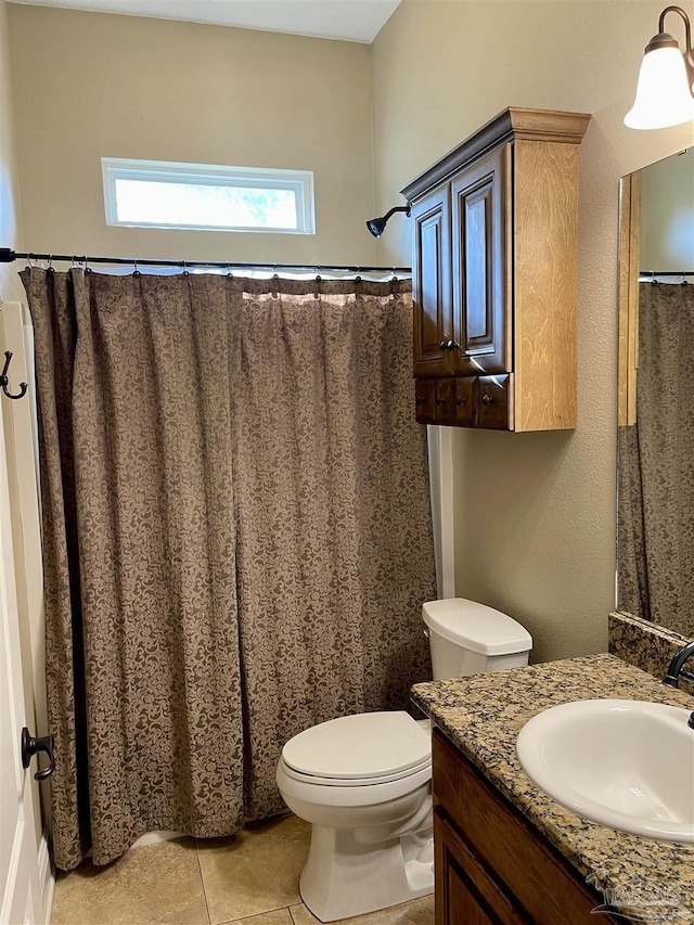 bathroom with tile patterned floors, vanity, and toilet