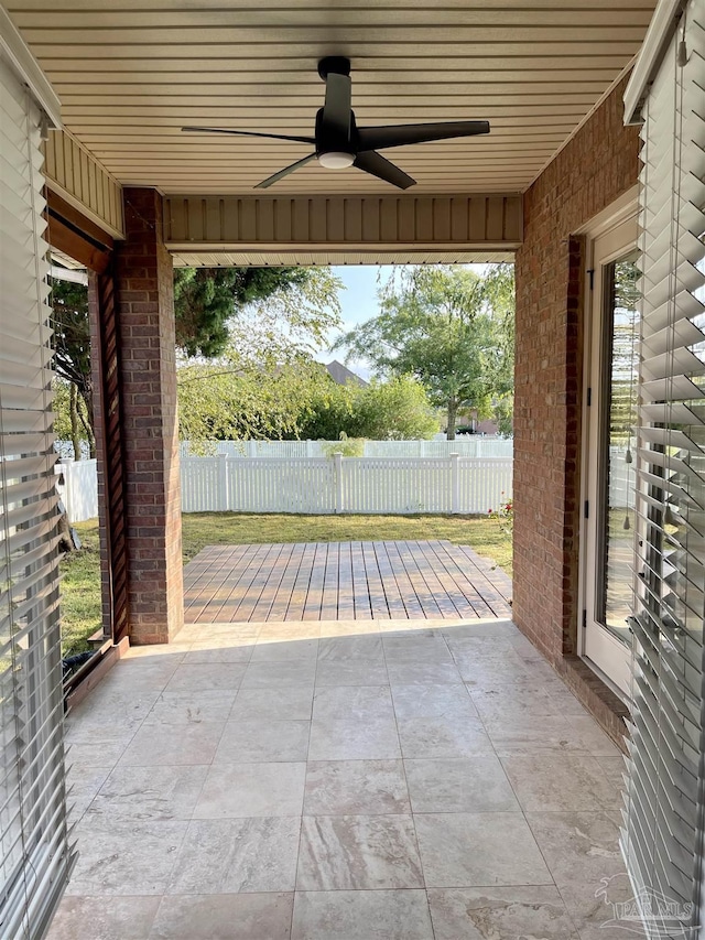 view of patio / terrace featuring fence and a ceiling fan
