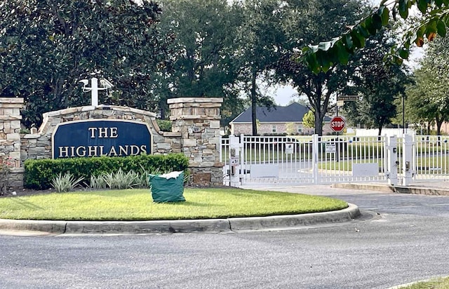 community sign with a gate and fence