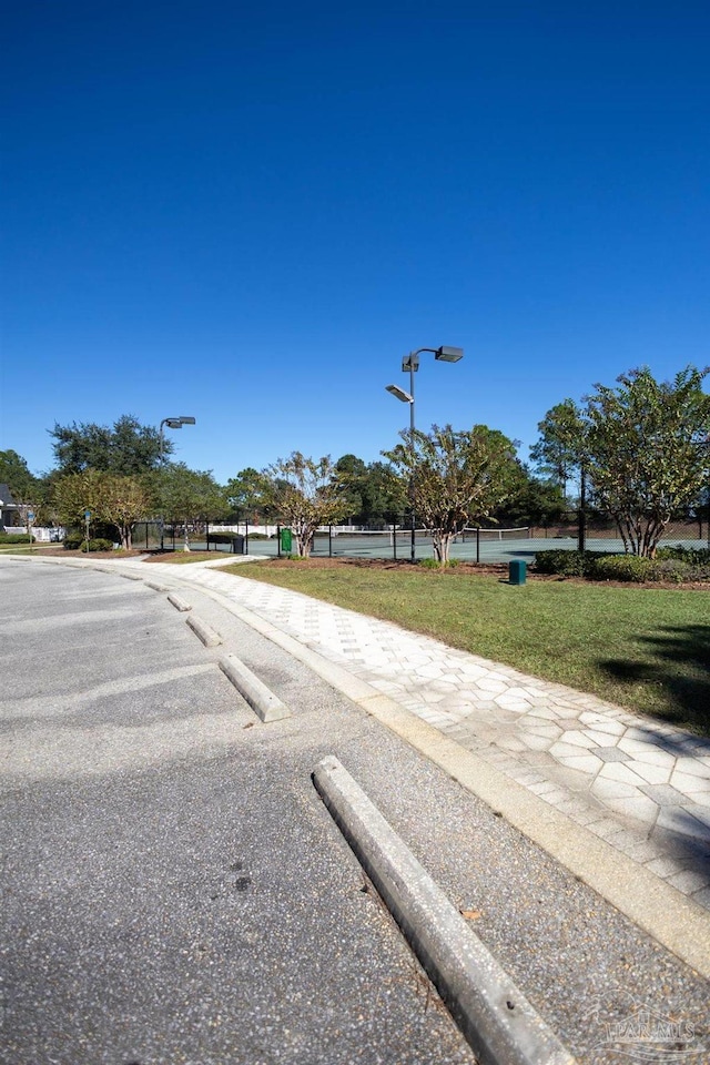 view of road with sidewalks, curbs, and street lighting