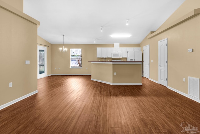 208 Millet Cir, Cantonment, FL 32533 - kitchen with visible vents, white appliances, lofted ceiling, and an inviting chandelier