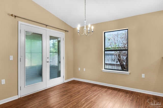 208 Millet Cir, Cantonment, FL 32533 - unfurnished room featuring lofted ceiling, baseboards, dark wood-type flooring, french doors, and a notable chandelier