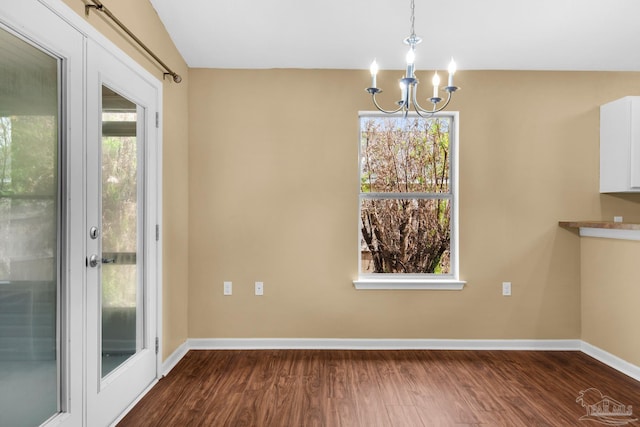 208 Millet Cir, Cantonment, FL 32533 - unfurnished dining area with an inviting chandelier, dark wood-style floors, and baseboards