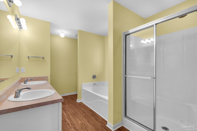 208 Millet Cir, Cantonment, FL 32533 - bathroom with wood finished floors, a shower stall, a garden tub, and a sink