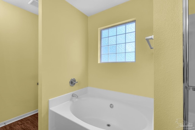 208 Millet Cir, Cantonment, FL 32533 - full bath with visible vents, wood finished floors, a bath, and baseboards
