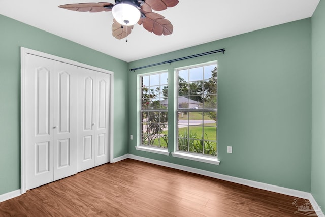 208 Millet Cir, Cantonment, FL 32533 - unfurnished bedroom with baseboards, wood finished floors, a ceiling fan, and a closet