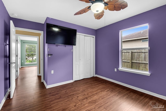 208 Millet Cir, Cantonment, FL 32533 - unfurnished bedroom featuring a closet, a ceiling fan, baseboards, and dark wood-type flooring