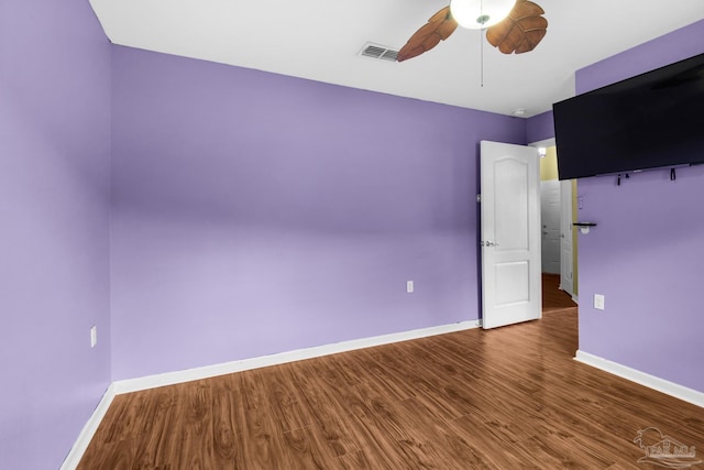 208 Millet Cir, Cantonment, FL 32533 - unfurnished room with wood finished floors, visible vents, ceiling fan, and baseboards