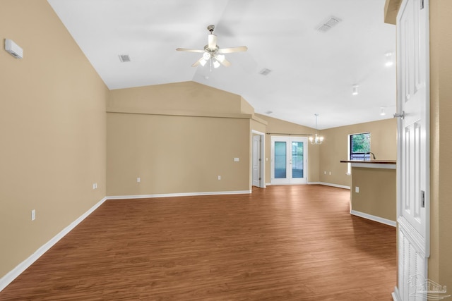 208 Millet Cir, Cantonment, FL 32533 - unfurnished living room featuring visible vents, wood finished floors, ceiling fan with notable chandelier, and vaulted ceiling