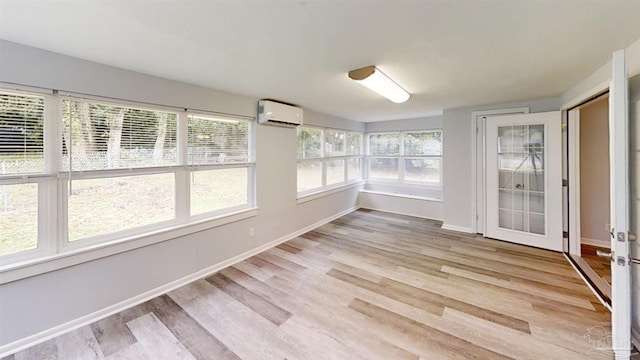 unfurnished sunroom with a wall mounted AC