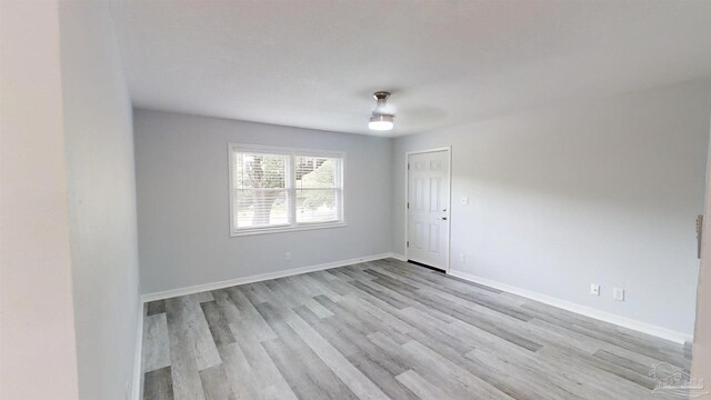 spare room with light hardwood / wood-style flooring and ceiling fan