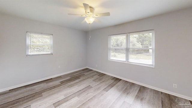 empty room featuring light hardwood / wood-style flooring and ceiling fan