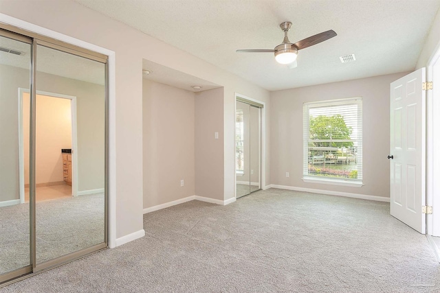 1090 Park Ln, Gulf Breeze, FL 32563 - unfurnished bedroom with baseboards, visible vents, ceiling fan, and light colored carpet
