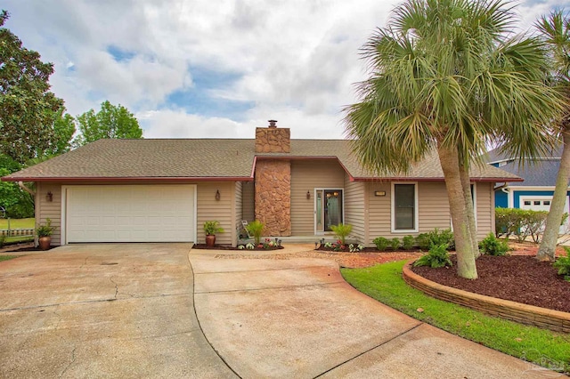 1090 Park Ln, Gulf Breeze, FL 32563 - view of front of house with an attached garage, driveway, and a chimney