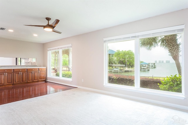 1090 Park Ln, Gulf Breeze, FL 32563 - unfurnished living room featuring a ceiling fan, baseboards, visible vents, and dark carpet
