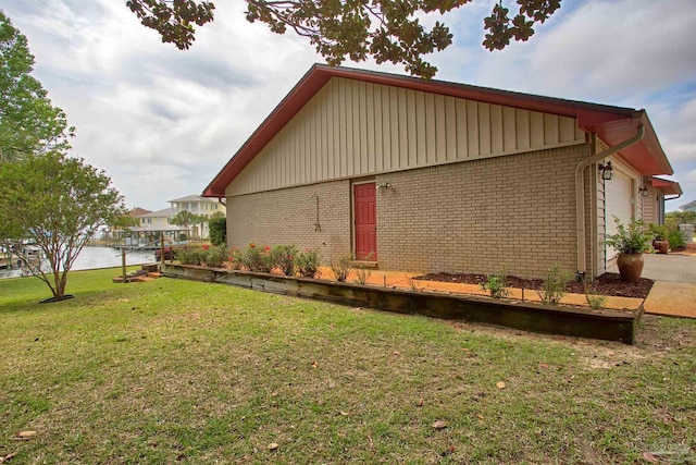 1090 Park Ln, Gulf Breeze, FL 32563 - view of property exterior featuring a lawn and brick siding