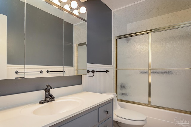 1090 Park Ln, Gulf Breeze, FL 32563 - bathroom with vanity, enclosed tub / shower combo, a wainscoted wall, and toilet
