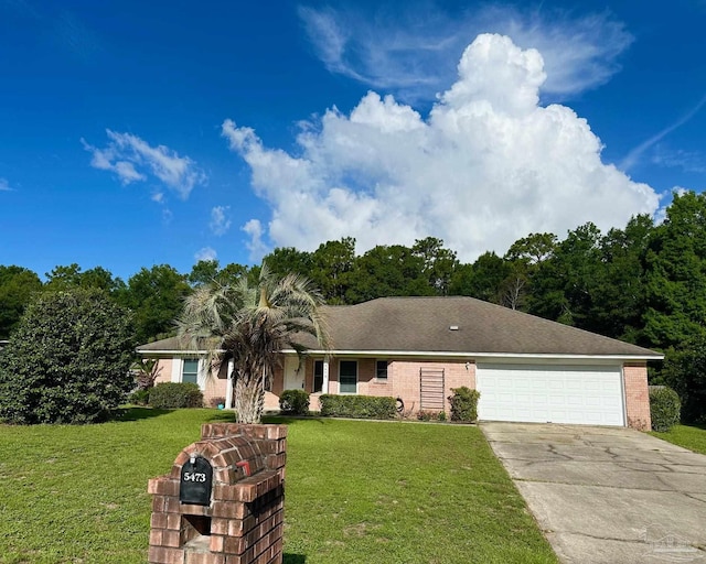 5473 Timber Creek Cir, Pace, FL 32571 - view of front of home with concrete driveway, a garage, a front lawn, and brick siding