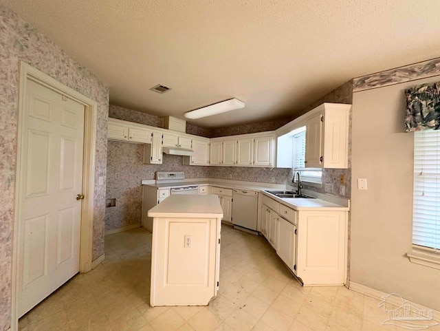 5473 Timber Creek Cir, Pace, FL 32571 - kitchen with white appliances, a kitchen island, under cabinet range hood, white cabinetry, and light flooring