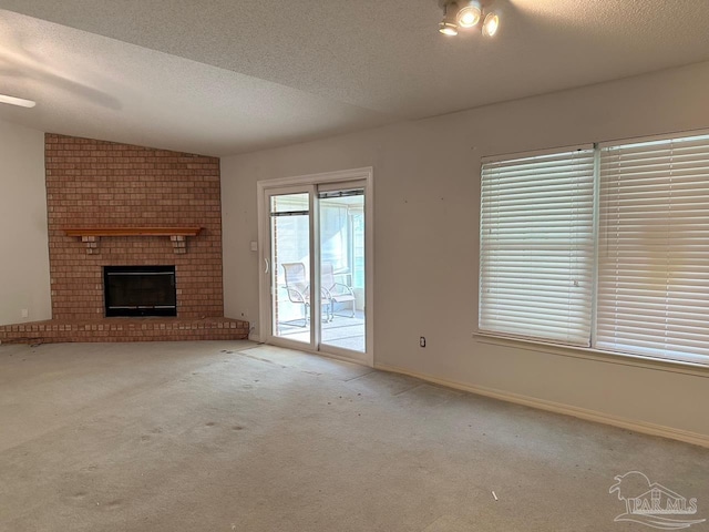 5473 Timber Creek Cir, Pace, FL 32571 - unfurnished living room with a textured ceiling, carpet flooring, and a fireplace