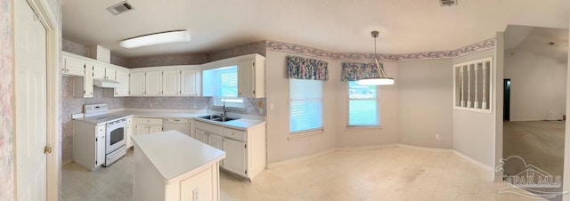 5473 Timber Creek Cir, Pace, FL 32571 - kitchen featuring white appliances, under cabinet range hood, a kitchen island, light countertops, and white cabinets