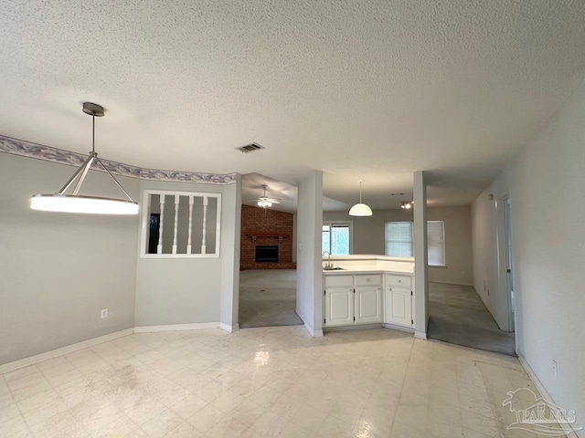 5473 Timber Creek Cir, Pace, FL 32571 - interior space featuring a brick fireplace and a textured ceiling