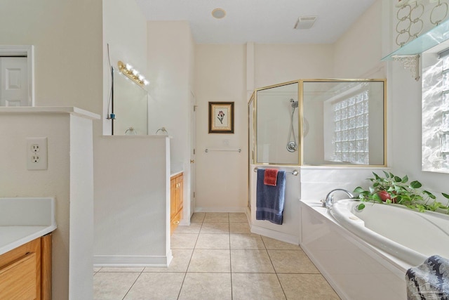 bathroom with tile patterned floors, vanity, and separate shower and tub