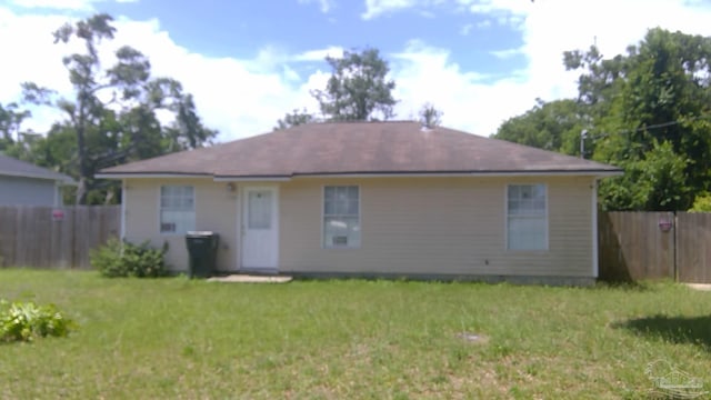 rear view of house with a lawn