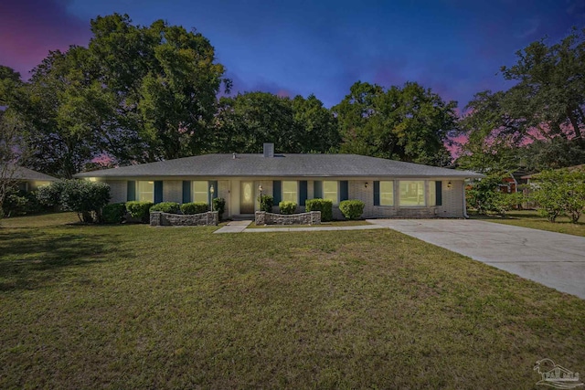 ranch-style home featuring a yard