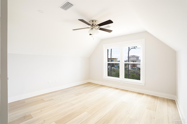 additional living space featuring ceiling fan, light wood-type flooring, and vaulted ceiling