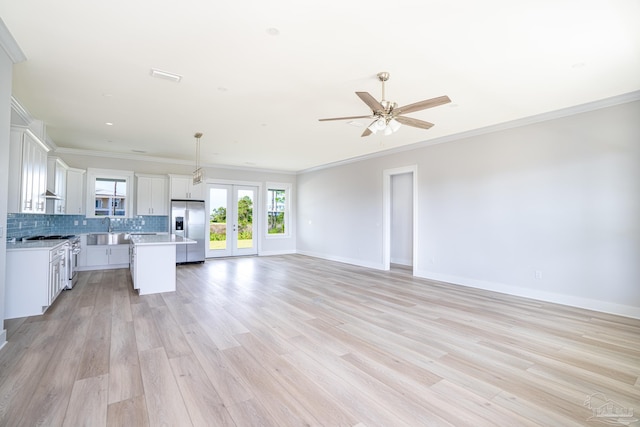 interior space with ceiling fan, french doors, light hardwood / wood-style floors, ornamental molding, and sink