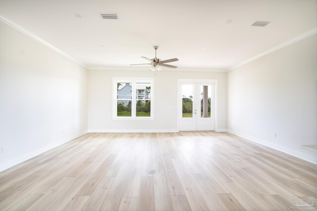 spare room featuring french doors, ornamental molding, and light hardwood / wood-style floors