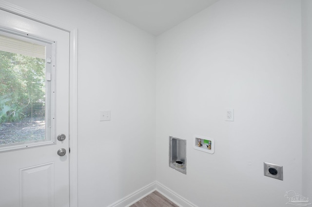 clothes washing area featuring hookup for a washing machine, electric dryer hookup, a healthy amount of sunlight, and hardwood / wood-style floors