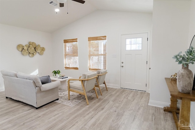 living room with ceiling fan, high vaulted ceiling, and light hardwood / wood-style flooring