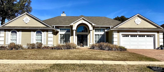 view of front of home with a garage and a front yard