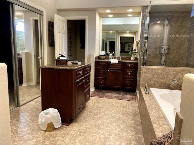 bathroom with vanity and separate shower and tub