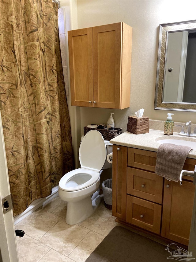 bathroom featuring vanity, tile patterned floors, and toilet