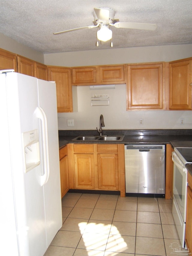 kitchen featuring sink, white appliances, light tile patterned floors, ceiling fan, and a textured ceiling