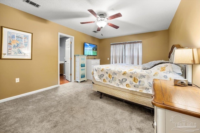 bedroom with connected bathroom, ceiling fan, carpet floors, and a textured ceiling