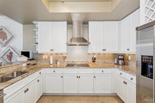 kitchen with white cabinetry, sink, stainless steel fridge with ice dispenser, black electric cooktop, and wall chimney exhaust hood