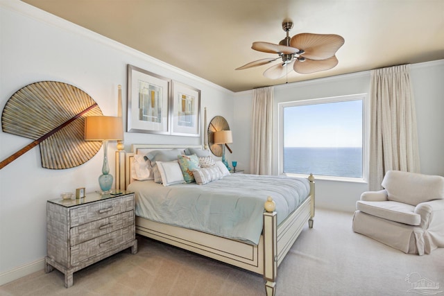 carpeted bedroom featuring a water view, ceiling fan, and ornamental molding