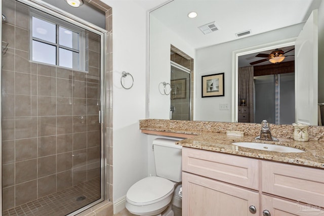 bathroom with vanity, an enclosed shower, ceiling fan, and toilet